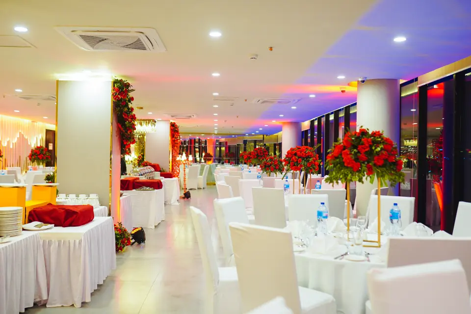 Banquet hall with red floral centrepieces at Melrose Arch