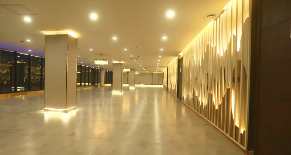 Empty event hall with illuminated feature wall at Melrose Arch