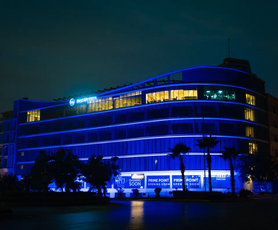 Melrose Arch facade lit in blue at night