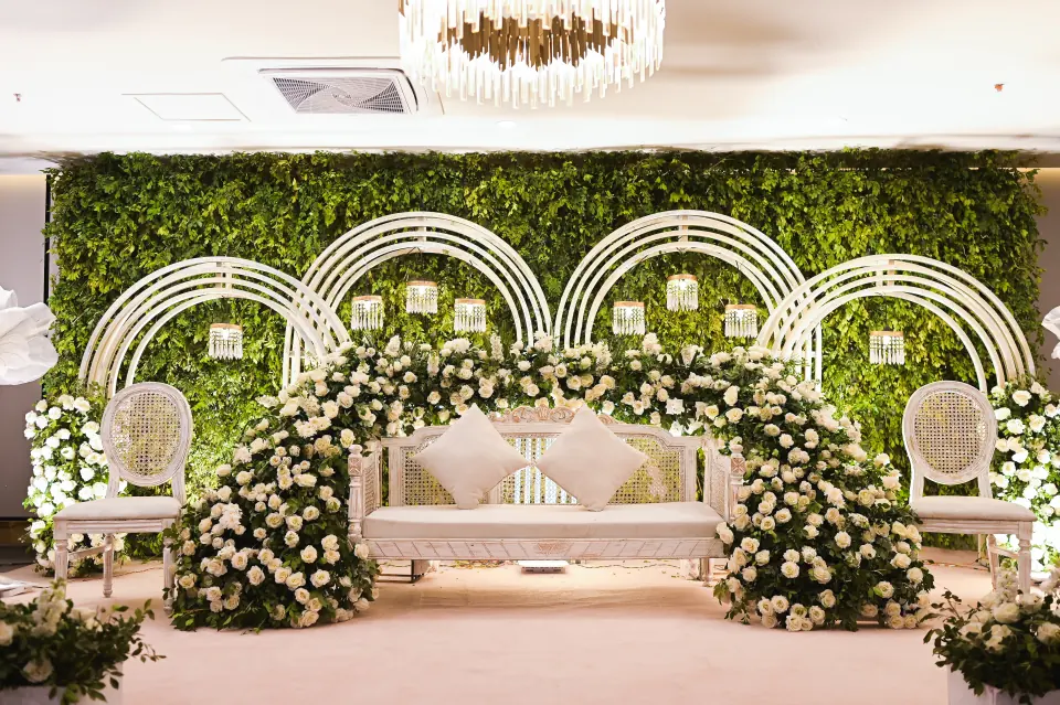 White floral arch event stage at Melrose Arch