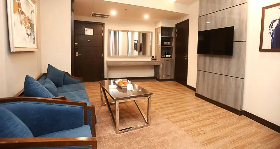 Suite living area with blue sofas at Best Western Rawalpindi Central