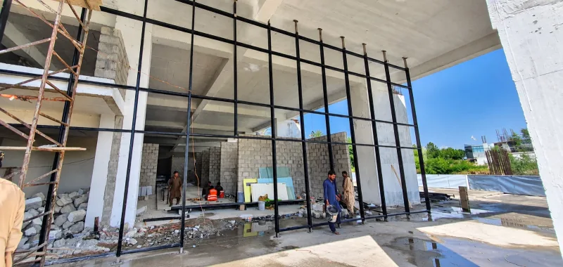 Workers installing the tall entrance curtain wall at Sky Luxe on 28 September 2026