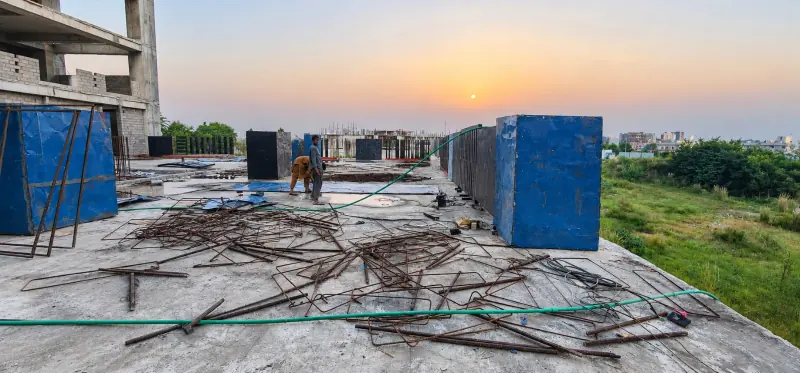 Construction team working on the Sky Luxe roof at sunset