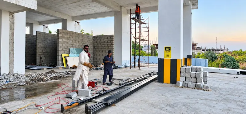 Workers carrying out steel works on an upper level of Sky Luxe