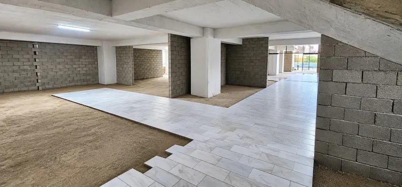 Floor tiles being installed inside Sky Luxe